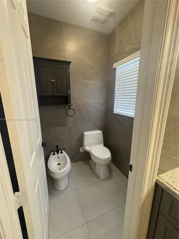 a view of backyard with plants and outdoor seating