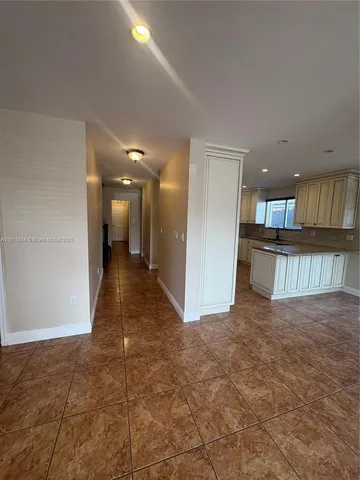 a view of an empty room with glass door
