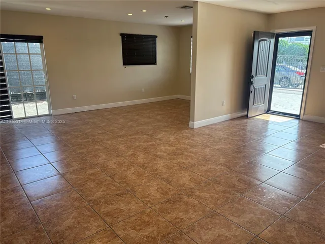 an empty room with windows and entrance