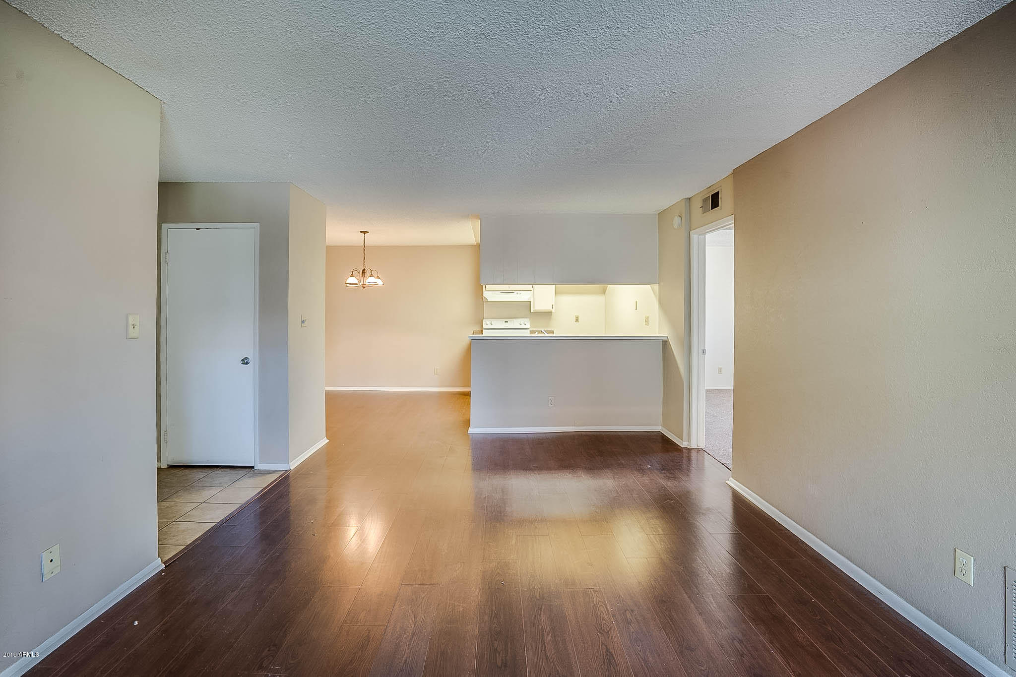 5525 East Thomas Road, Unit R12 Phoenix, AZ 85018 - Photo 2 of 14 a view of a livingroom with wooden floor