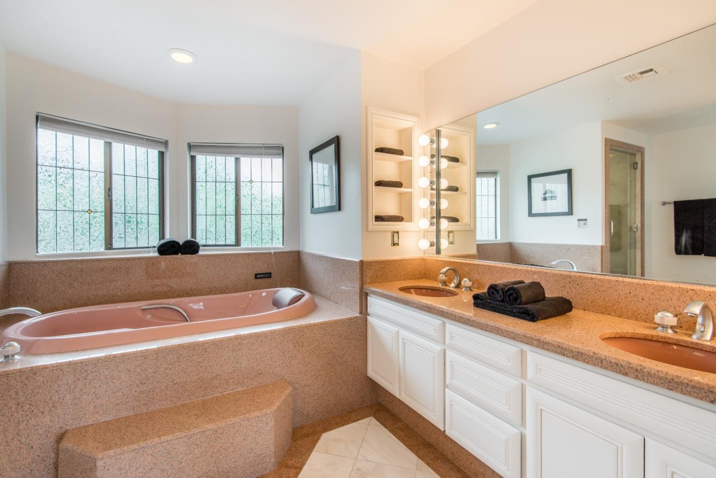760 Darrell Road Hillsborough, CA 94010 - Photo 19 of 35 a bath tub sitting next to a bathroom sink and vanity