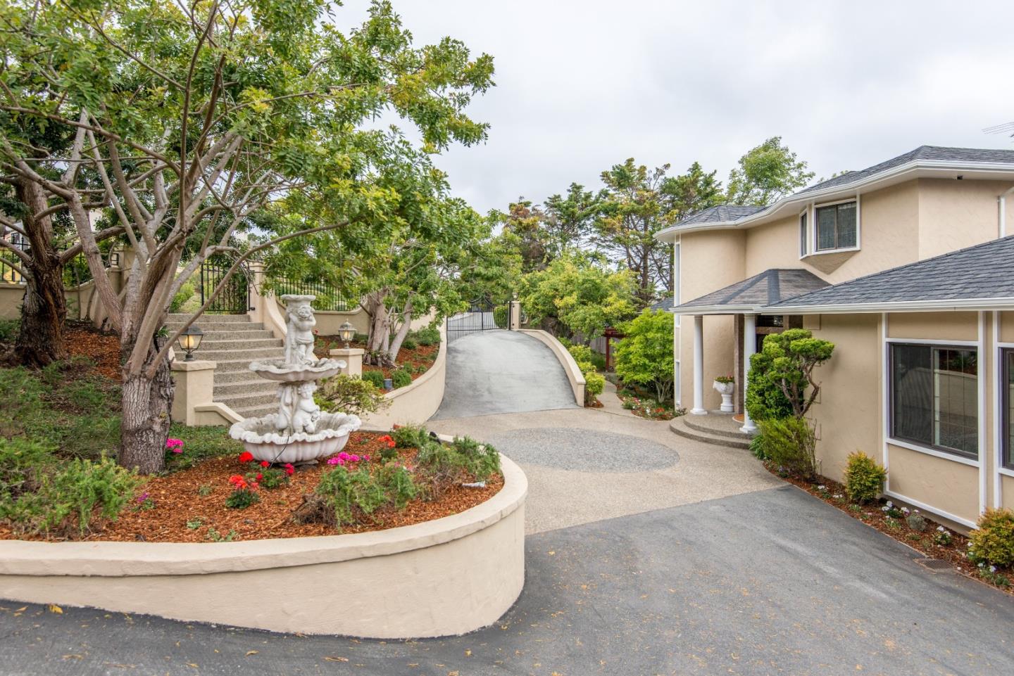 760 Darrell Road Hillsborough, CA 94010 - Photo 2 of 35 a view of a house with a small yard and a garden
