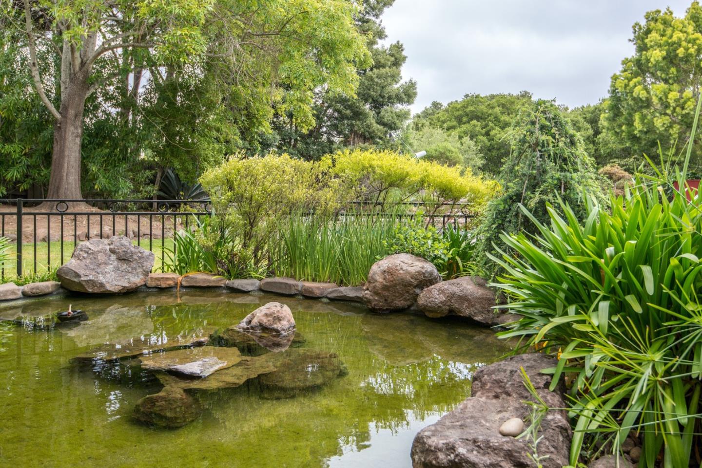 760 Darrell Road Hillsborough, CA 94010 - Photo 27 of 35 a view of a lake with couches chairs
