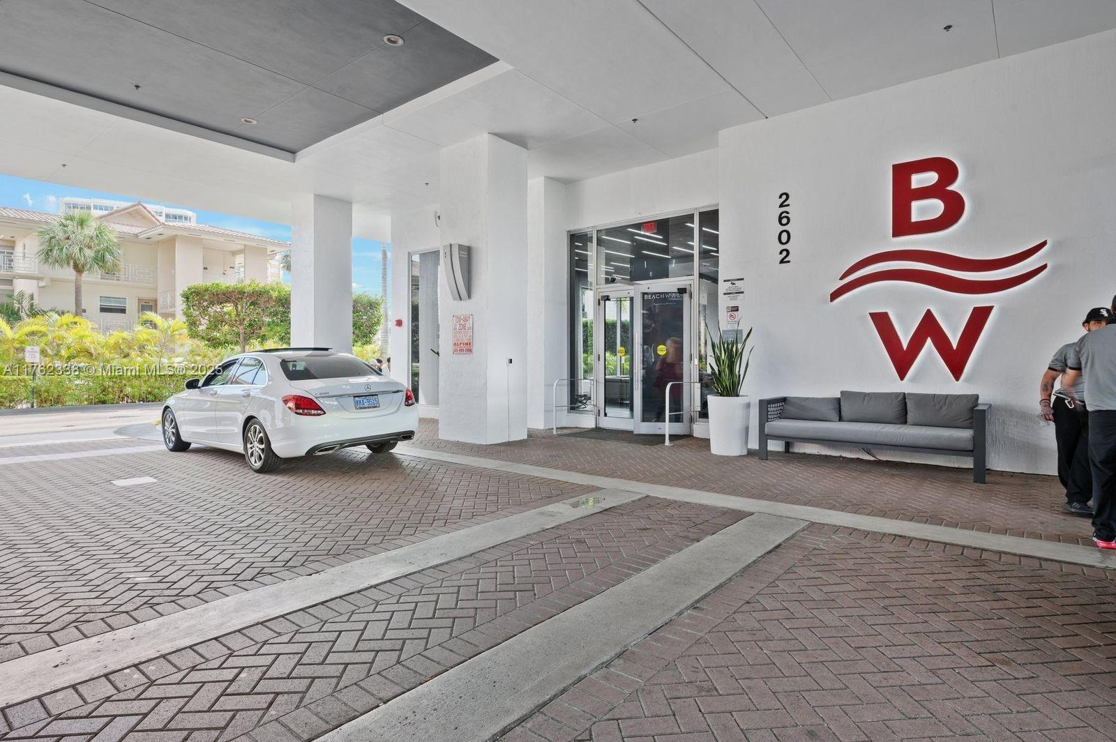 2602 East Hallandale Beach Boulevard, Unit R2703 Hallandale Beach, FL 33009 - Photo 18 of 50 a living room with furniture and a floor to ceiling window