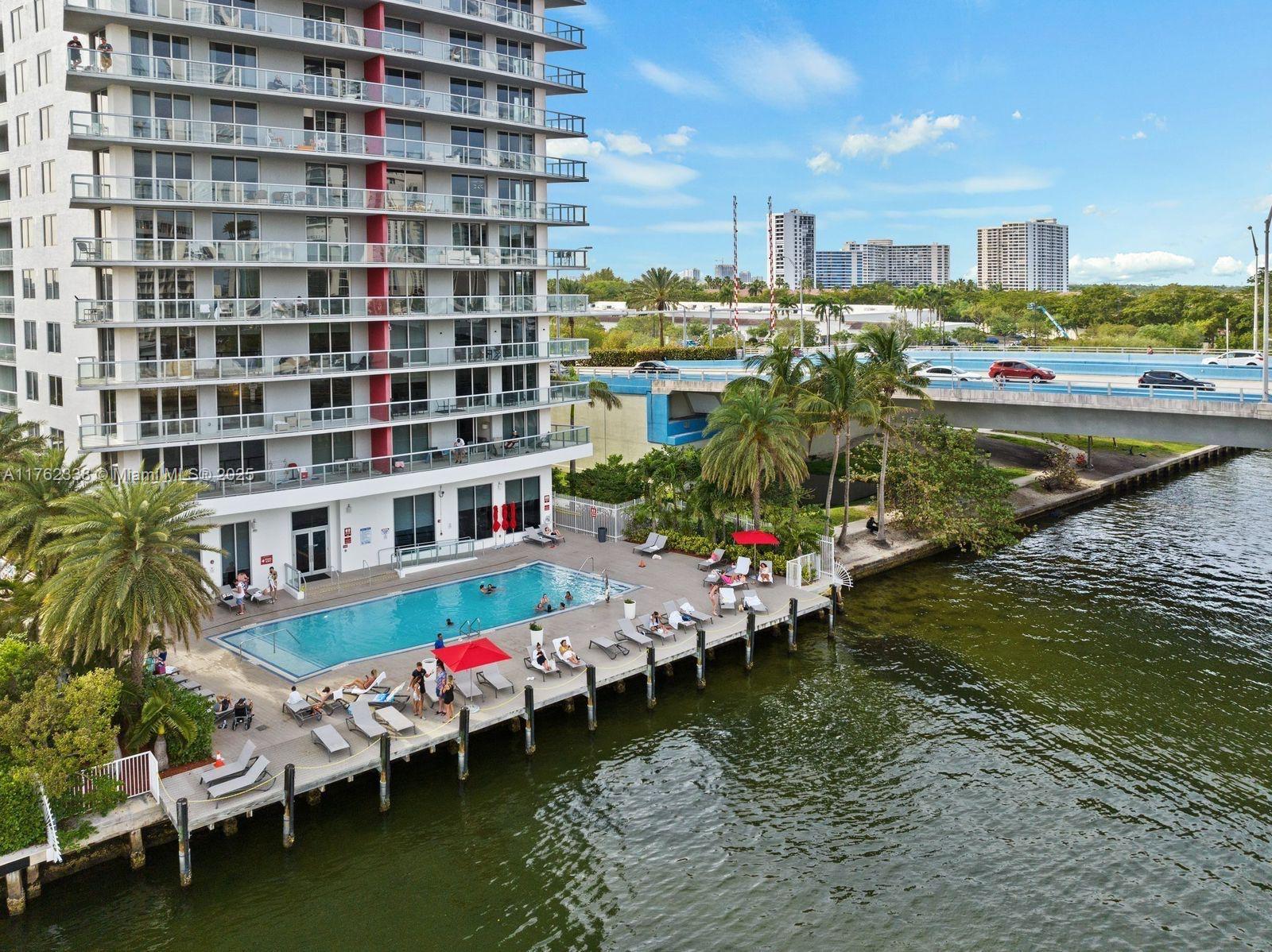 2602 East Hallandale Beach Boulevard, Unit R2703 Hallandale Beach, FL 33009 - Photo 45 of 50 a view of swimming pool with outdoor seating and plants