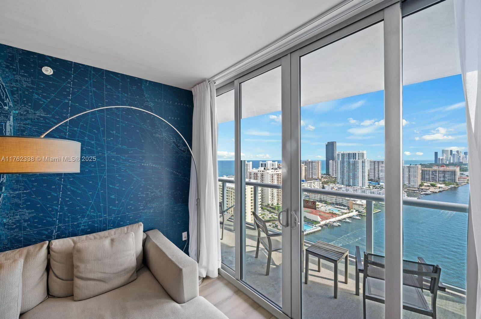 2602 East Hallandale Beach Boulevard, Unit R2703 Hallandale Beach, FL 33009 - Photo 7 of 50 a living room with furniture and a floor to ceiling window