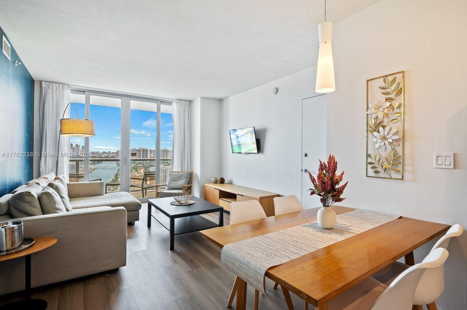 2602 East Hallandale Beach Boulevard, Unit R2703 Hallandale Beach, FL 33009 - Photo 8 of 50 a living room with furniture and a large window