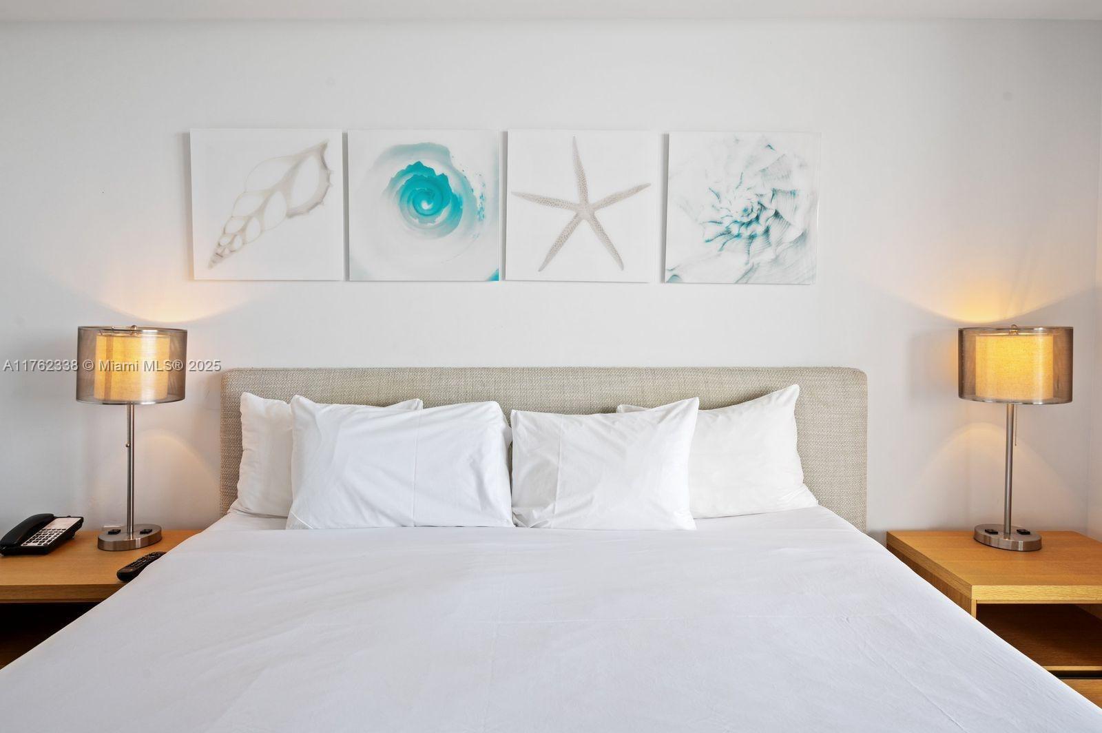 2602 East Hallandale Beach Boulevard, Unit R2703 Hallandale Beach, FL 33009 - Photo 9 of 50 a bedroom with a bed and a lamp