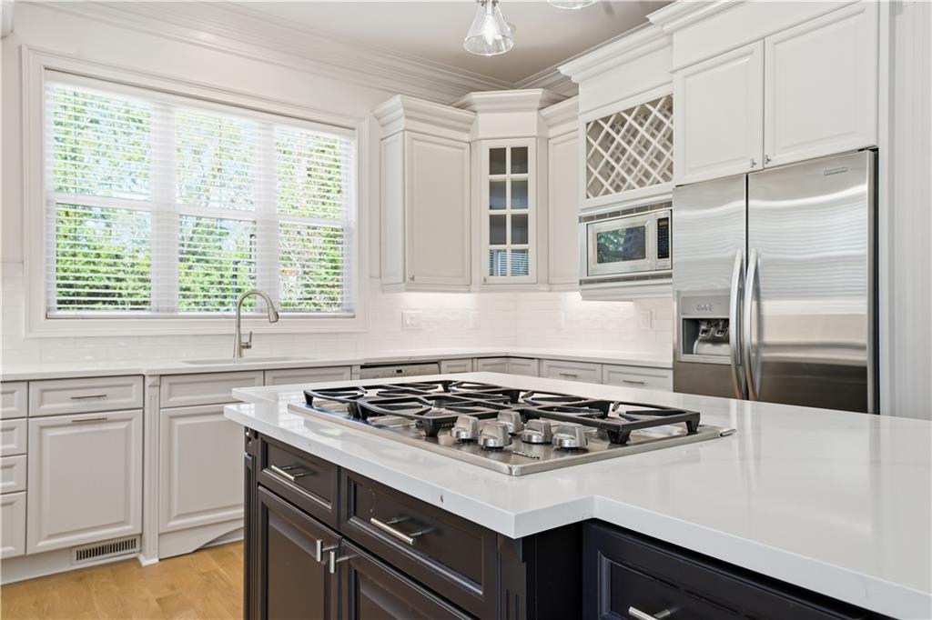 6740 Castleton Drive Northwest Sandy Springs, GA 30328 - Photo 20 of 58 a kitchen with a stove a sink and a refrigerator