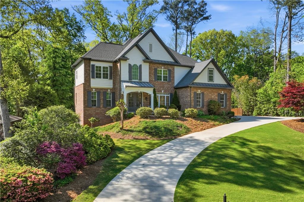 6740 Castleton Drive Northwest Sandy Springs, GA 30328 - Photo 2 of 58 a front view of a house with a yard and fountain