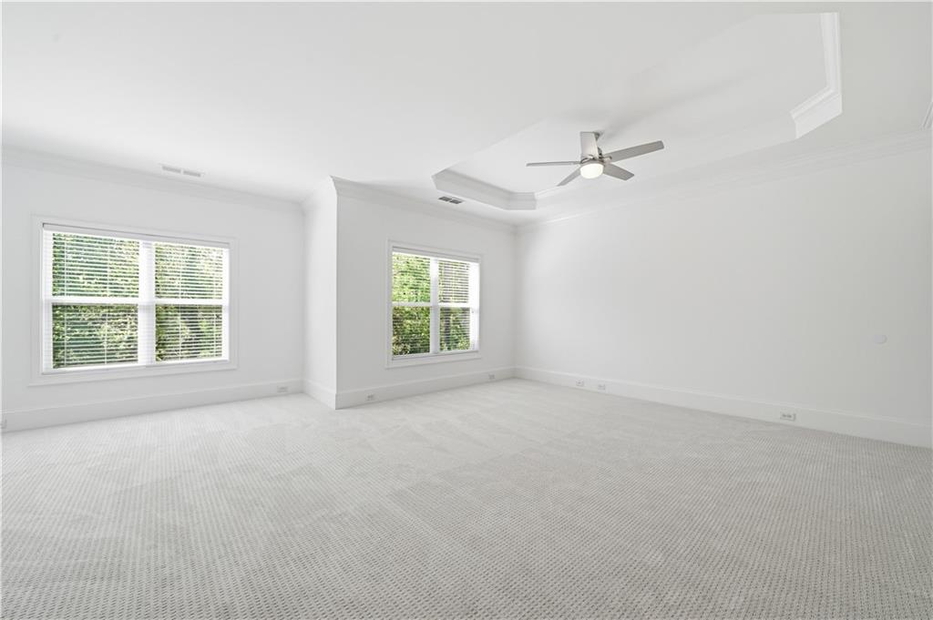 6740 Castleton Drive Northwest Sandy Springs, GA 30328 - Photo 26 of 58 an empty room with windows and fan