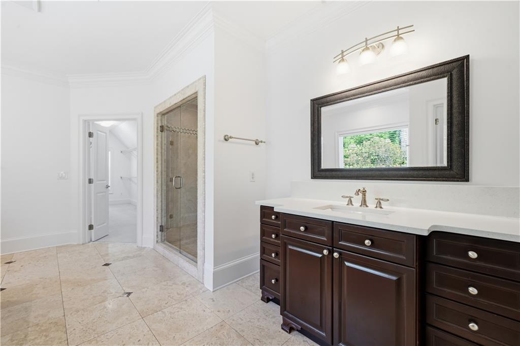 6740 Castleton Drive Northwest Sandy Springs, GA 30328 - Photo 28 of 58 a bathroom with a sink a mirror and a shower