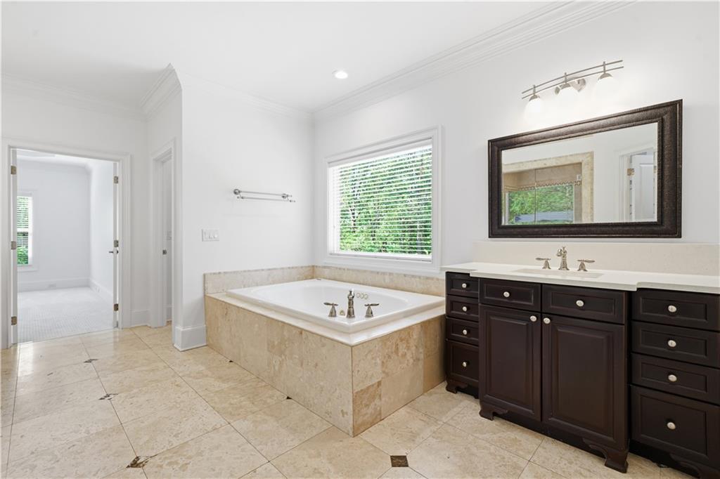 6740 Castleton Drive Northwest Sandy Springs, GA 30328 - Photo 29 of 58 a bathroom with a sink a mirror and a bathtub