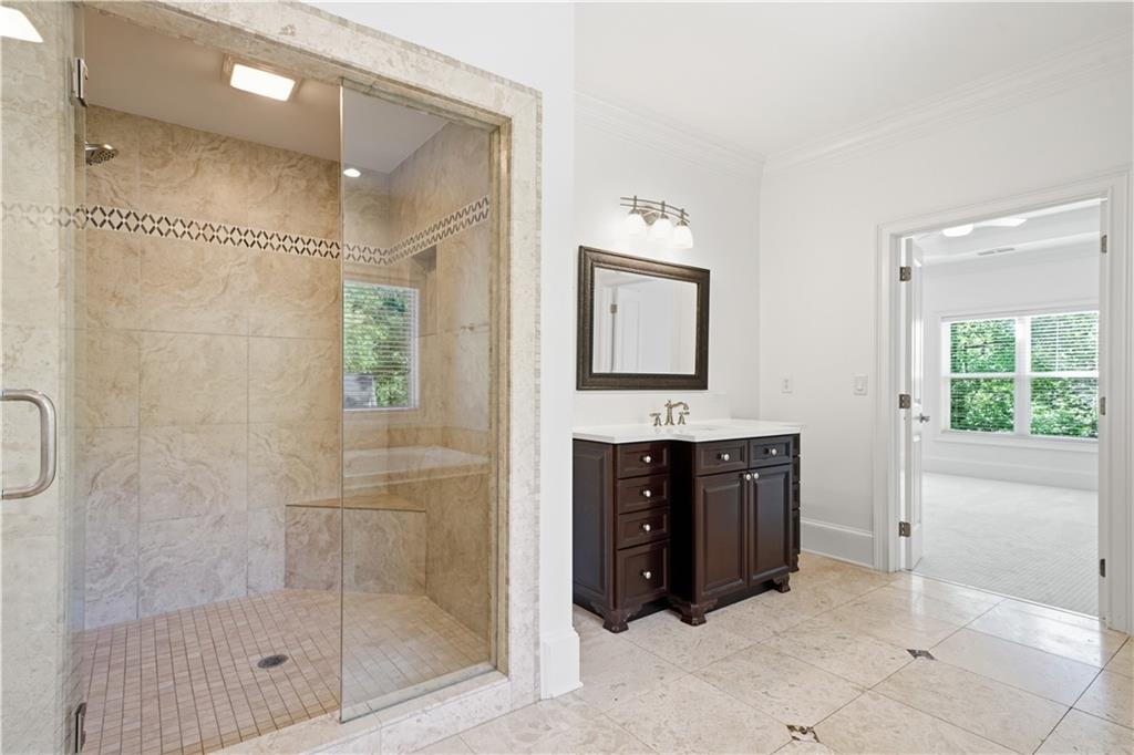 6740 Castleton Drive Northwest Sandy Springs, GA 30328 - Photo 30 of 58 a spacious bathroom with a shower sink and mirror