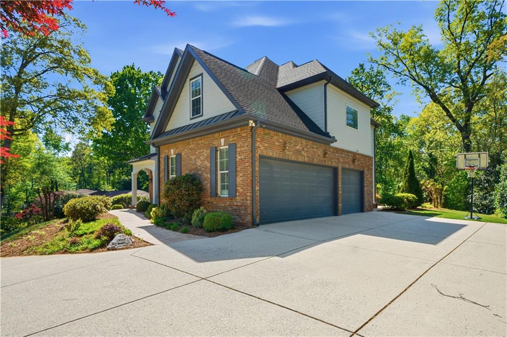 6740 Castleton Drive Northwest Sandy Springs, GA 30328 - Photo 3 of 58 a front view of a house with a yard and a garage