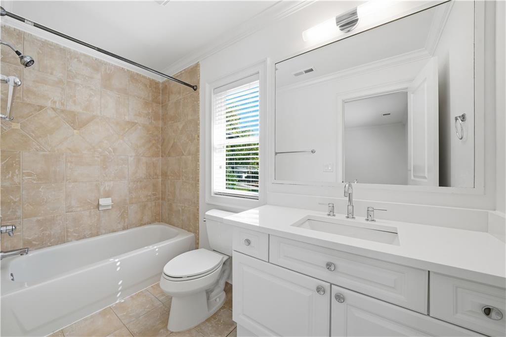 6740 Castleton Drive Northwest Sandy Springs, GA 30328 - Photo 33 of 58 a bathroom with a sink a toilet a mirror and bathtub