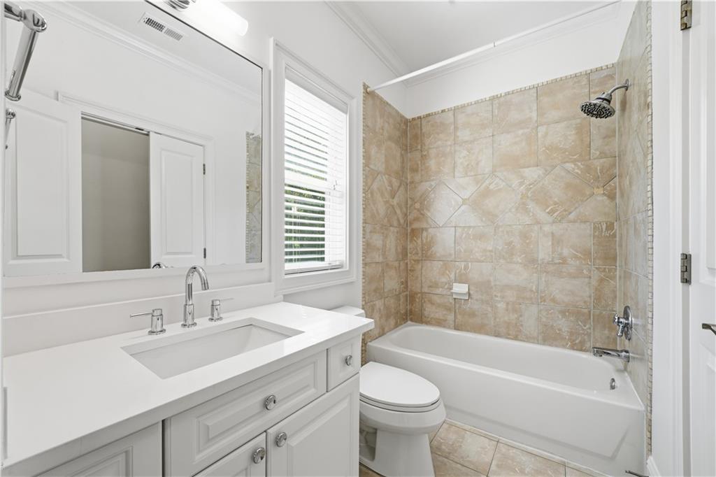 6740 Castleton Drive Northwest Sandy Springs, GA 30328 - Photo 35 of 58 a bathroom with a sink mirror toilet and bathtub