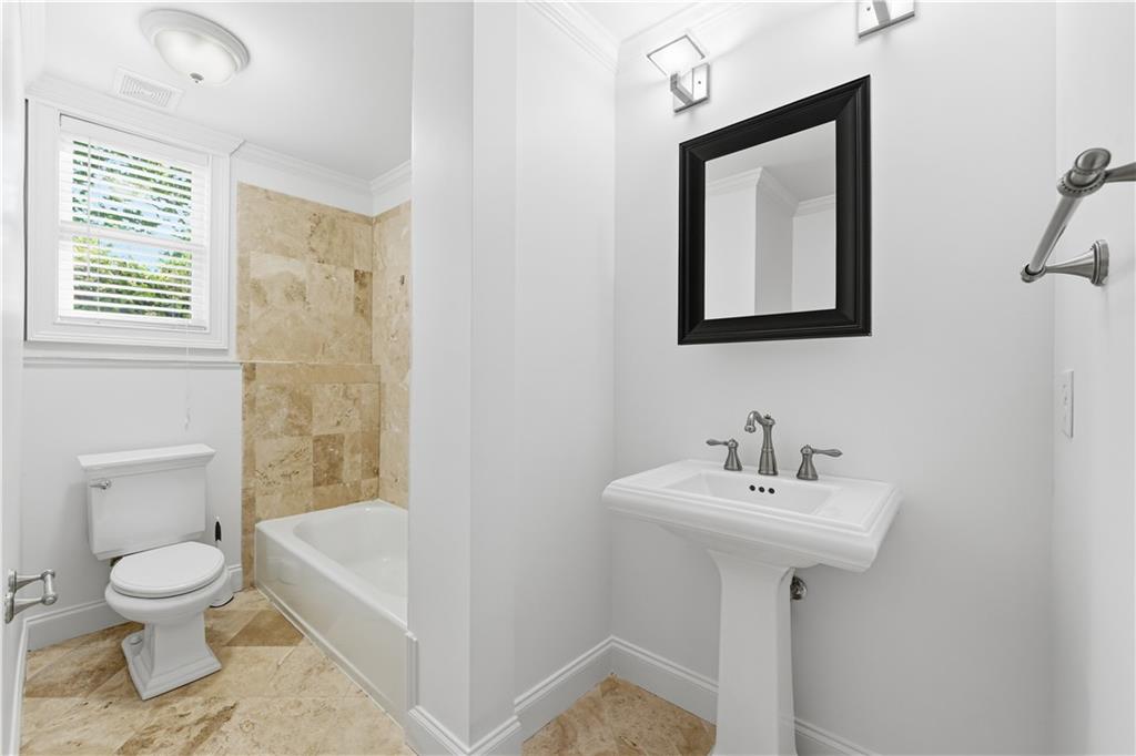 6740 Castleton Drive Northwest Sandy Springs, GA 30328 - Photo 37 of 58 a bathroom with a toilet sink and mirror