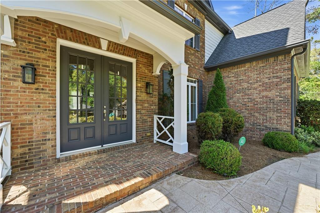 6740 Castleton Drive Northwest Sandy Springs, GA 30328 - Photo 4 of 58 a view of a brick house with large windows and plants