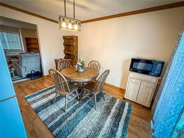 a dining room with furniture and wooden floor