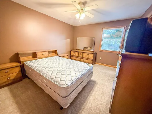 a living room with a bed furniture and a window