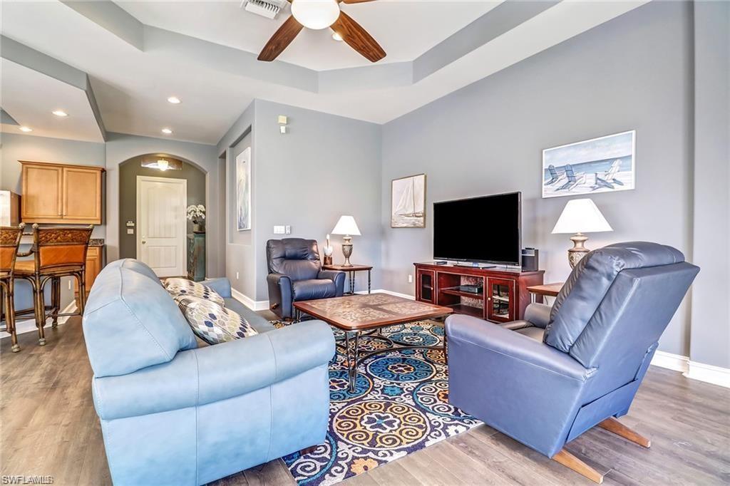 1374 Serrano Circle Naples, FL 34105 - Photo 13 of 37 a living room with furniture and a flat screen tv