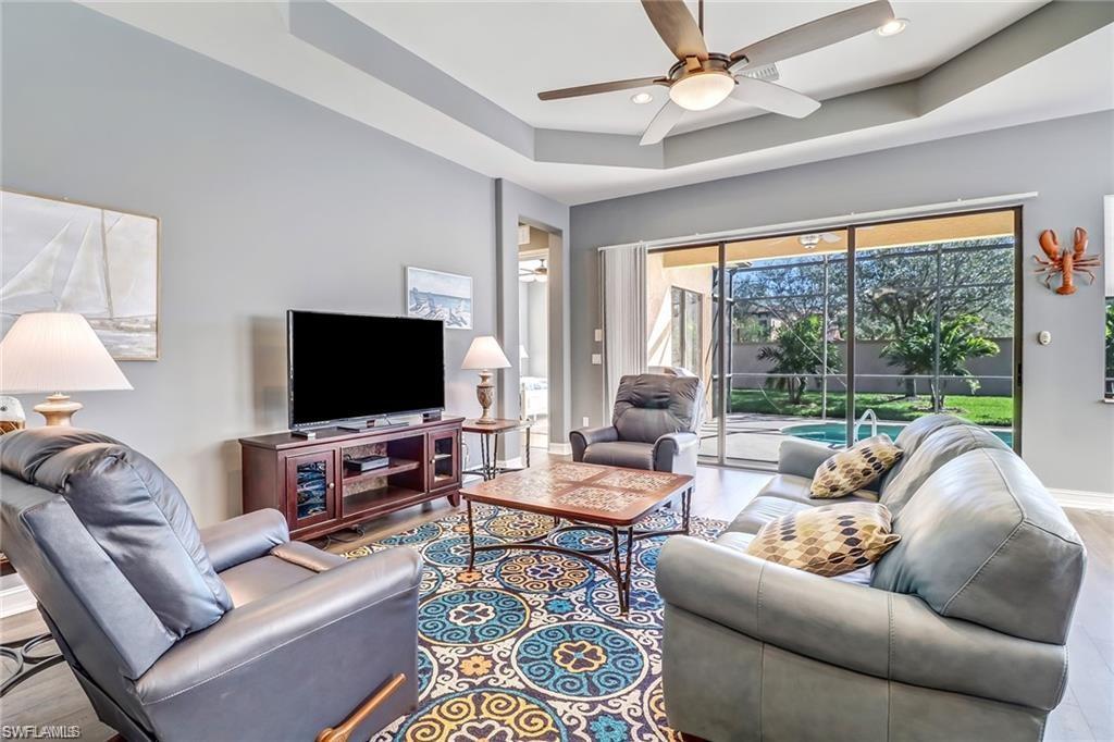1374 Serrano Circle Naples, FL 34105 - Photo 14 of 37 a living room with furniture and a flat screen tv