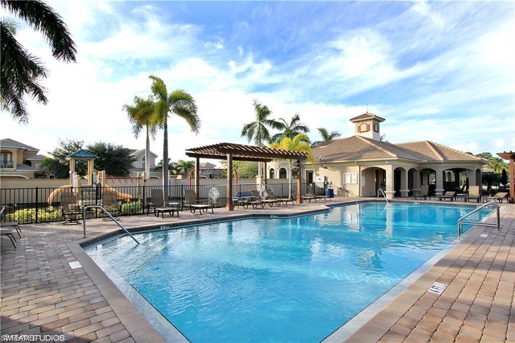 1374 Serrano Circle Naples, FL 34105 - Photo 16 of 37 a front view of house with yard and swimming pool
