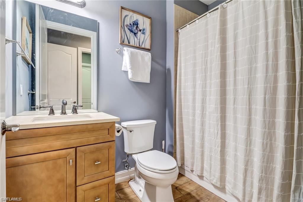 1374 Serrano Circle Naples, FL 34105 - Photo 18 of 37 a bathroom with a sink and a toilet