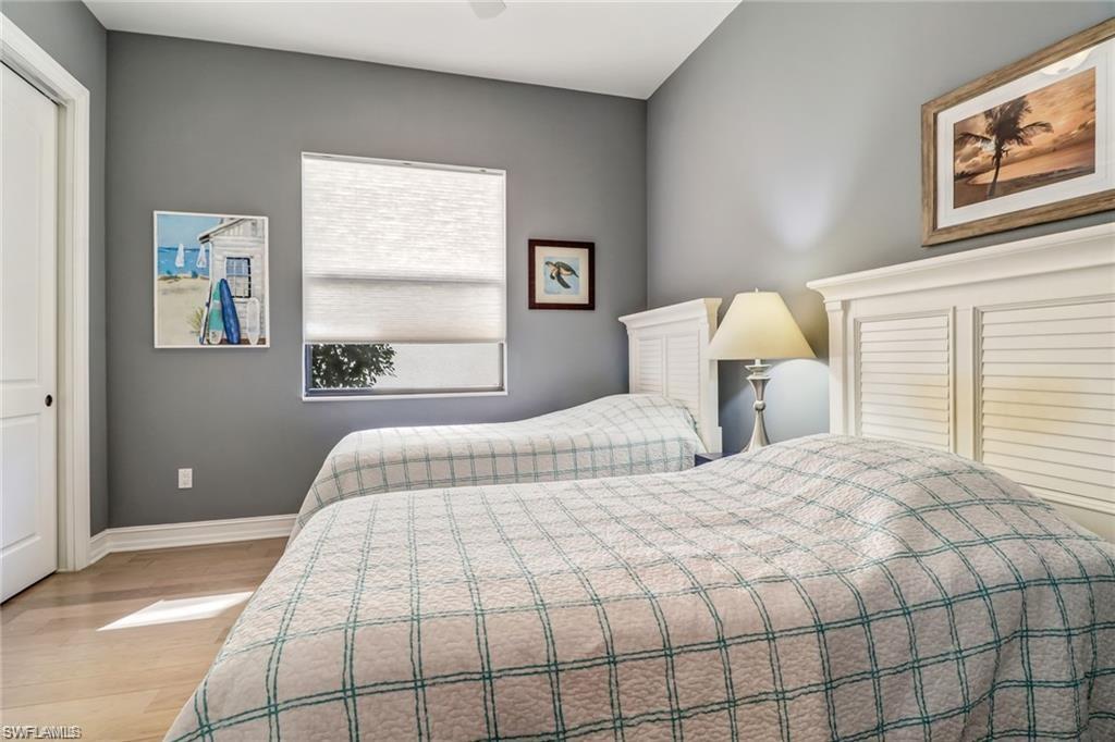 1374 Serrano Circle Naples, FL 34105 - Photo 19 of 37 a bedroom with a bed and a window
