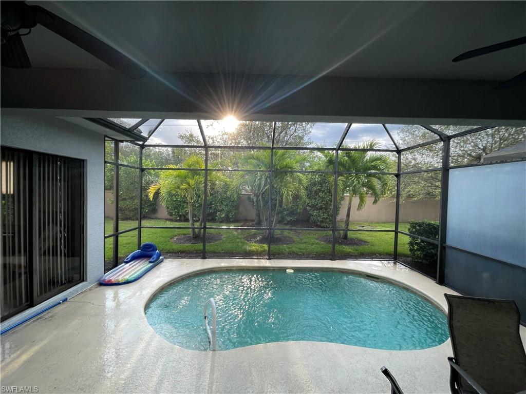 1374 Serrano Circle Naples, FL 34105 - Photo 20 of 37 a swimming pool with outdoor seating yard