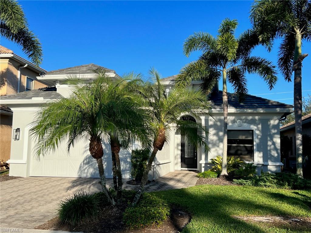 1374 Serrano Circle Naples, FL 34105 - Photo 2 of 37 a front view of house with yard and green space