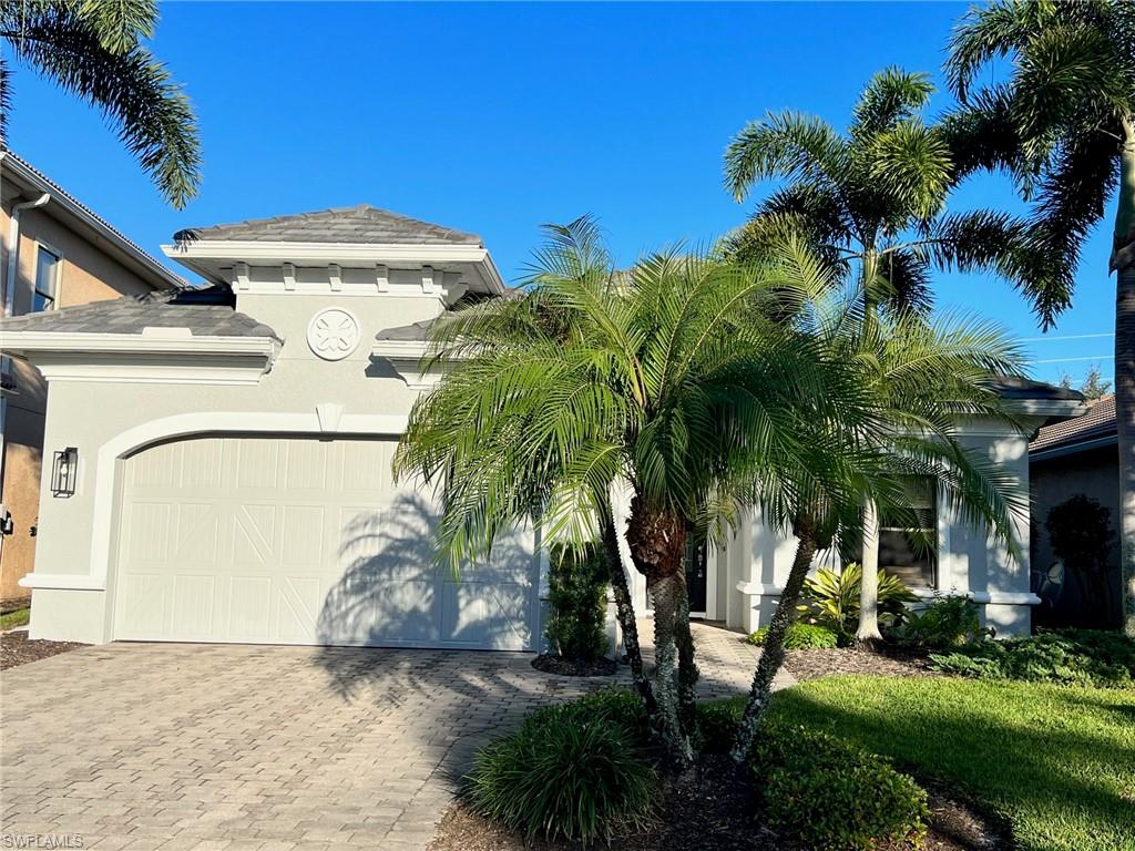 1374 Serrano Circle Naples, FL 34105 - Photo 3 of 37 a view of a backyard with potted plants