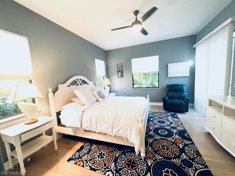 1374 Serrano Circle Naples, FL 34105 - Photo 34 of 37 a bedroom with a bed and a chandelier