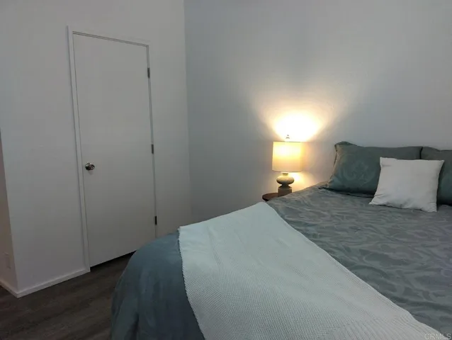 a bedroom with a bed and a lamp