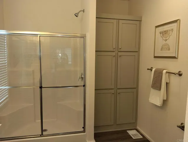 a bathroom with a glass shower door