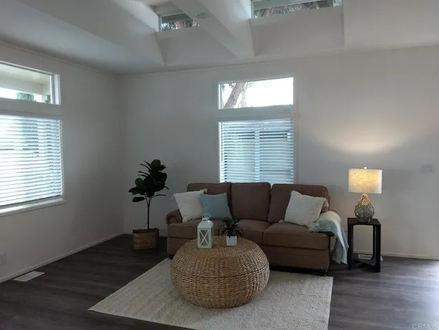 a living room with furniture and a potted plant