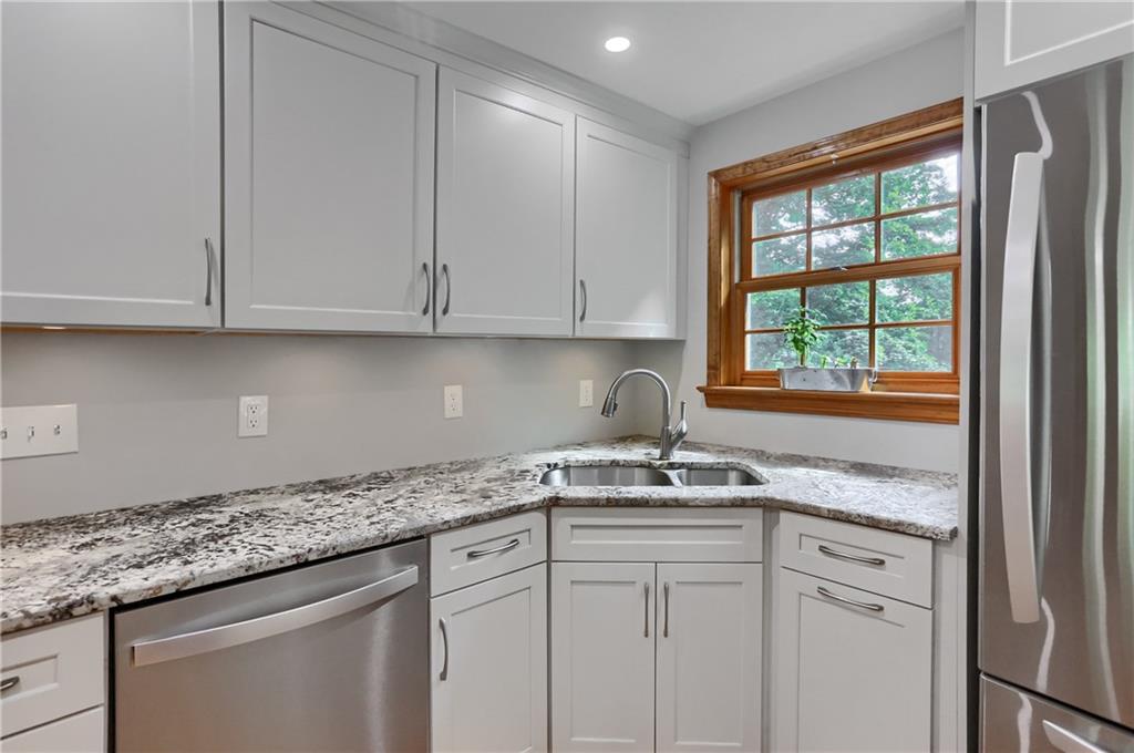 836 Harmony Road Pittsburgh, PA 15237 - Photo 28 of 46 a kitchen with granite countertop stainless steel appliances white cabinets and a window