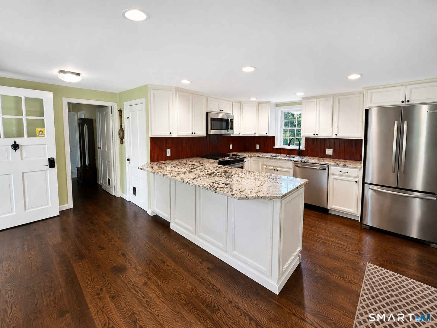 443 Amity Road Bethany, CT 06524 - Photo 9 of 30 a kitchen with stainless steel appliances granite countertop a refrigerator a stove a sink dishwasher and a refrigerator with wooden floor