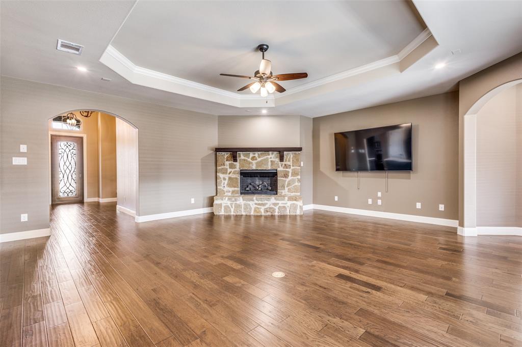 2143 Canyon Road Celina, TX 75009 - Photo 11 of 39 a view of an empty room with wooden floor fireplace and a window