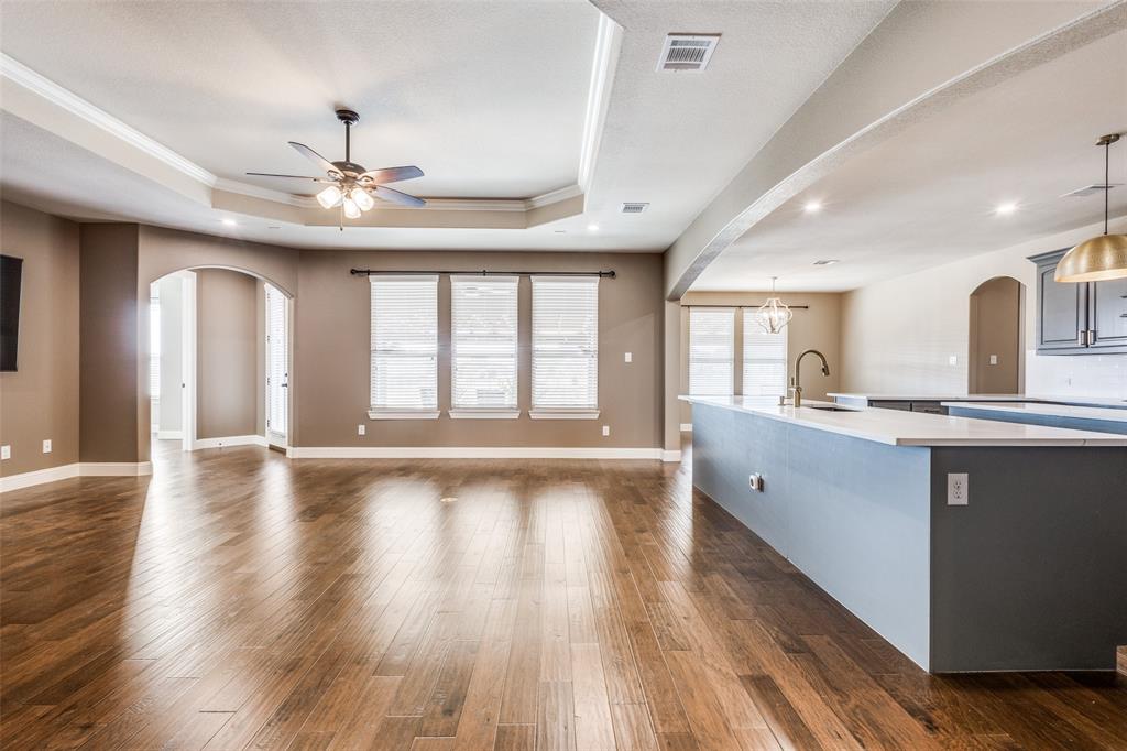 2143 Canyon Road Celina, TX 75009 - Photo 12 of 39 a large kitchen with chandelier and wooden floors