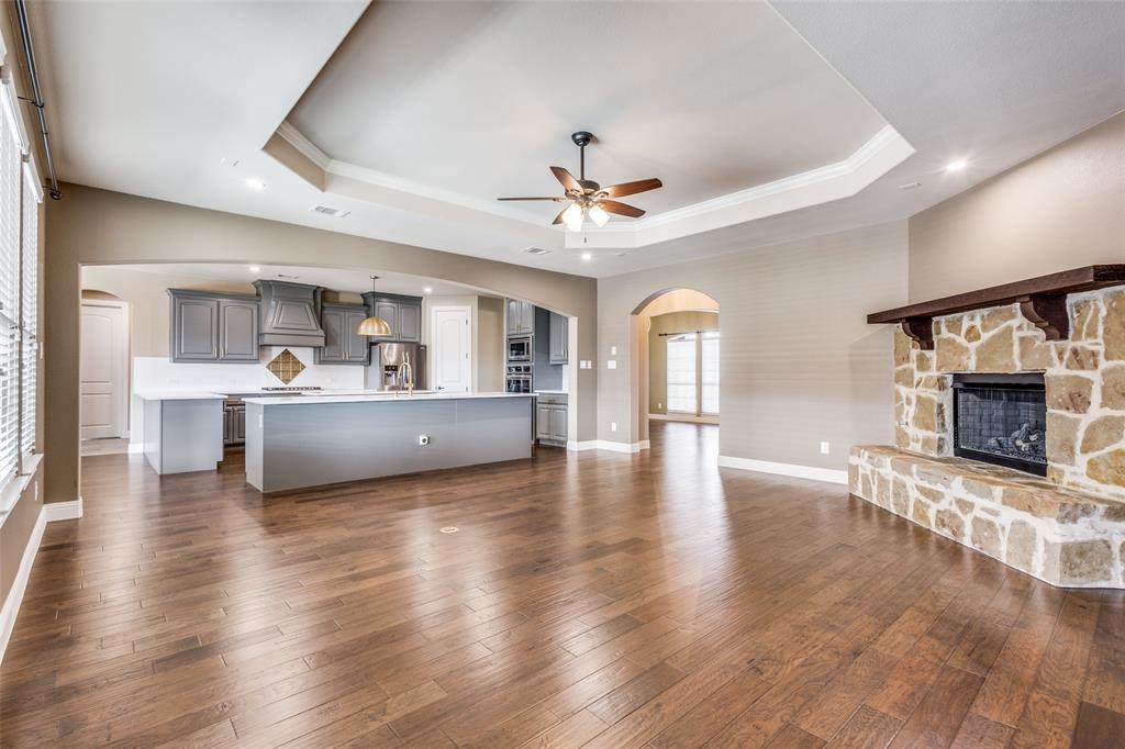 2143 Canyon Road Celina, TX 75009 - Photo 13 of 39 a view of a big room with wooden floor and a kitchen