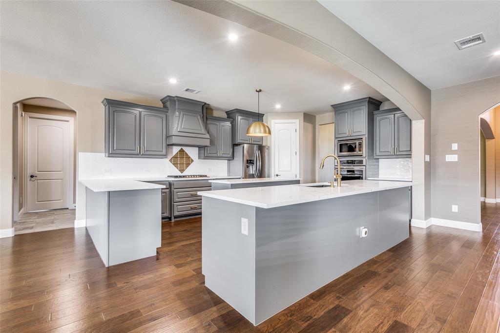 2143 Canyon Road Celina, TX 75009 - Photo 16 of 39 a kitchen with stainless steel appliances granite countertop a refrigerator a sink and a stove