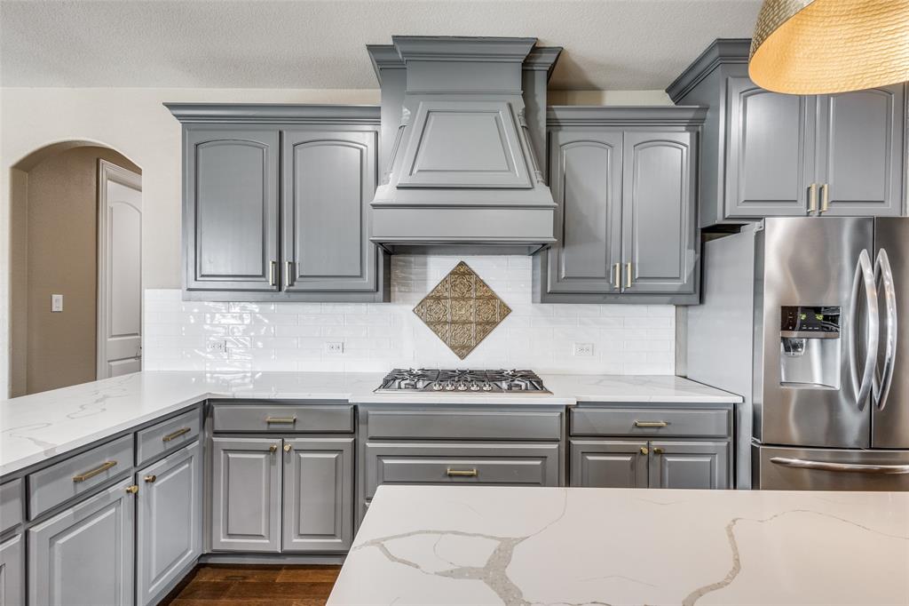 2143 Canyon Road Celina, TX 75009 - Photo 20 of 39 a kitchen with stainless steel appliances granite countertop a refrigerator a stove and a sink