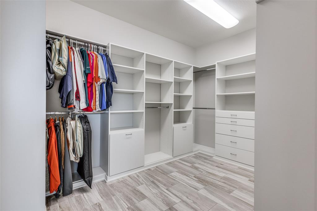 2143 Canyon Road Celina, TX 75009 - Photo 25 of 39 a view of walk in closet with clothes and shoes
