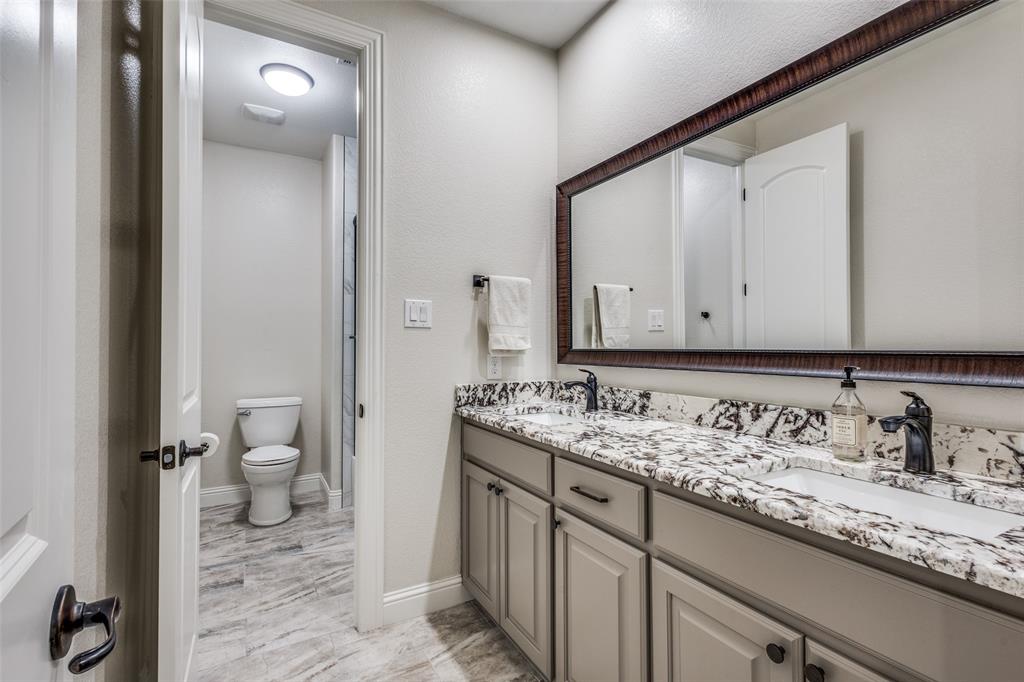 2143 Canyon Road Celina, TX 75009 - Photo 29 of 39 a bathroom with a granite countertop sink and a mirror