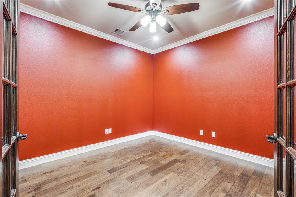 2143 Canyon Road Celina, TX 75009 - Photo 9 of 39 en empty room with wooden floor and fan