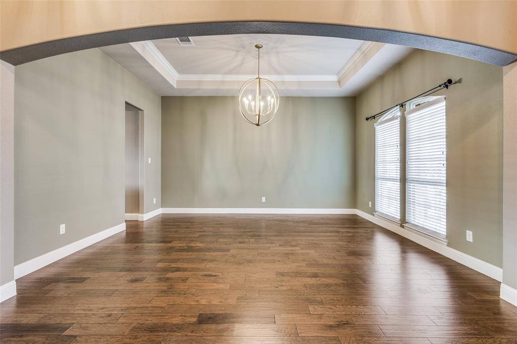 2143 Canyon Road Celina, TX 75009 - Photo 10 of 39 a view of an empty room with wooden floor and a window