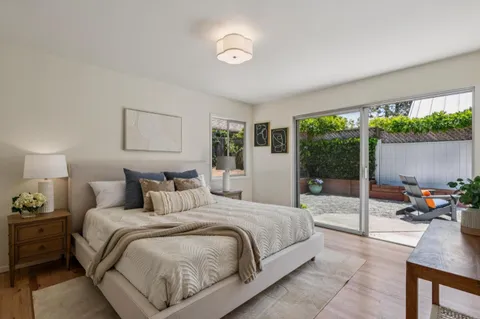a bedroom with a bed and a lamp next to a window