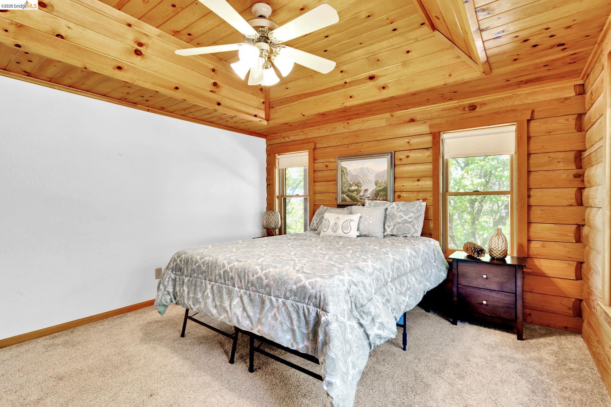14799 Big Hill Road Sonora, CA 95370 - Photo 21 of 60 Bedroom featuring wood ceiling, light colored carpet, and ceiling fan